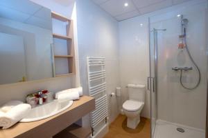 a bathroom with a toilet and a sink and a shower at Hôtel Miléade L'Orangeraie - Menton in Menton