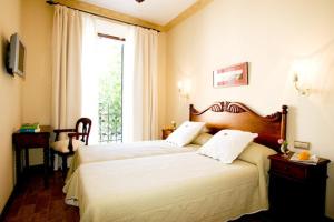 Voodi või voodid majutusasutuse Hotel la Vila toas
