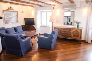 a living room with a couch and chairs and a table at Penthouse Presernovo nabrezje in Piran