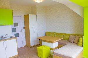 a living room with a couch and a table at Complex Chayka Guest House in Byala