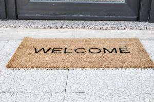 a welcome mat in front of a door at Olivia Rooms Eurialo in Belvedere