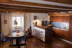 a kitchen and dining room with a table and chairs at Penthouse Presernovo nabrezje in Piran