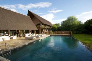 a resort with a swimming pool and a building at Cresta Mowana Safari Resort & Spa in Kasane