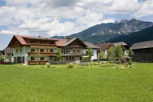 a large house in a field with a playground at Hansbauerhof in Rattendorf