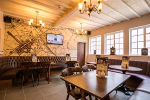 a restaurant with tables and chairs and a map on the wall at White Lion Royal Hotel in Bala