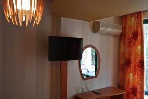 a living room with a flat screen tv on the wall at Tanya Hotel in Sunny Beach