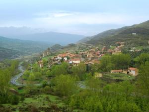a small town on a hill with a winding road at La Colmenita in Navalsaz