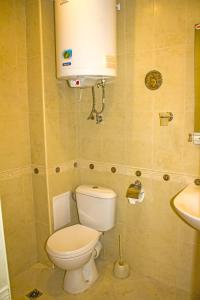 a small bathroom with a toilet and a sink at Complex Chayka Guest House in Byala +21 photos