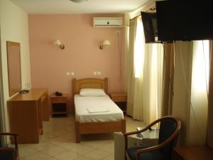 a small room with a bed and a tv in it at Cybele Guest Accommodation in Athens