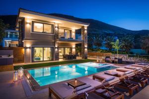 a villa with a swimming pool in front of a house at Villa Crete in Hersonissos