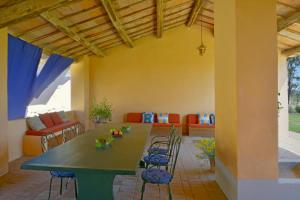 a living room with a table and a couch at Apartment I Fontanili in Pescia Romana