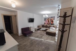 a living room with a couch and a chair at Oneiro Resort in Mamaia Sat/Năvodari
