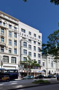 a white building with a sign on the side of it at Hotel Continental Hamburg Hauptbahnhof in Hamburg