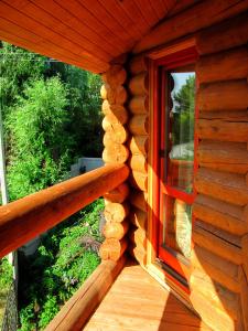 a wooden porch of a log cabin with a window at Green Style in Kyiv