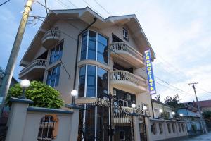 a building with a sign in front of it at Prenoćište Kovač in Vranje