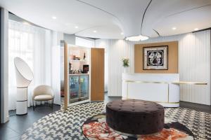 a living room with a large chocolate cake on the floor at Hôtel Pastel Paris in Paris +18 photos