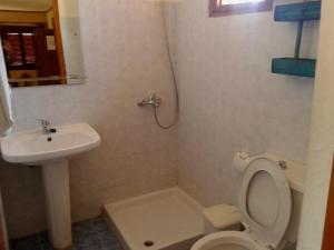a bathroom with a toilet and a sink at Sunrise Apartments in Palekastron