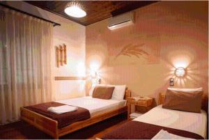 En eller flere senger på et rom på Guesthouse Patavalis