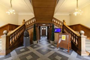 a staircase in a building with a lobby at Abdij Hotel Rolduc in Kerkrade