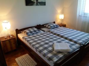 a bedroom with a bed with two pillows on it at Apartment Eva in Rakovica