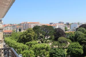 a view of a city with trees and buildings at Hôtel & Espace Bien-être La Maison du Lierre in Biarritz
