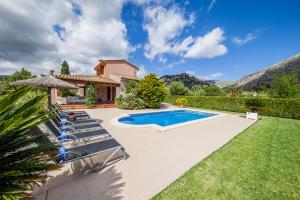 a villa with a swimming pool and lawn at Villa Rostoya in Pollença