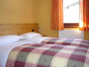 Posteľ alebo postele v izbe v ubytovaní Chalet Alberti