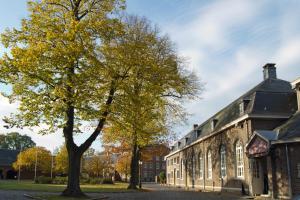 a tree in front of a building at Abdij Hotel Rolduc in Kerkrade