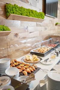 a buffet with plates of food on a table at Theatre Hotel in Olomouc