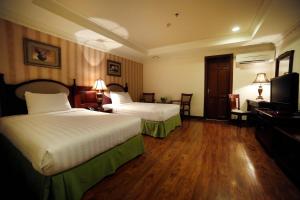 Säng eller sängar i ett rum på Villa Caceres Hotel