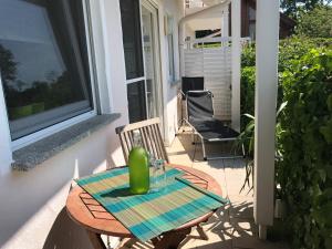 a table and chairs on the porch of a house at Ferienwohnung Creutzig in Stockach