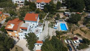 - une vue aérienne sur une maison avec une piscine dans l'établissement Apartmani Mihaela II, à Baška