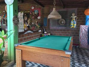 a pool table in front of a house at Pousada Casa Colorida in Porto De Galinhas