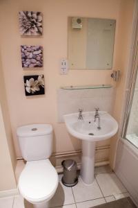 a bathroom with a toilet and a sink at City Centre Luxury Holiday Apartment in Liverpool