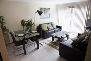 a living room with a table and a couch at City Centre Luxury Holiday Apartment in Liverpool