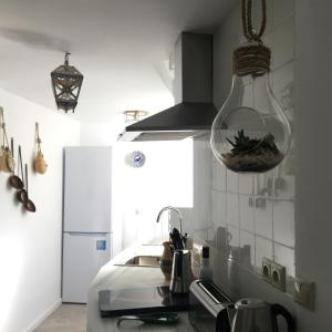 a kitchen with a glass bowl hanging from the ceiling at Mezquita Home in Córdoba