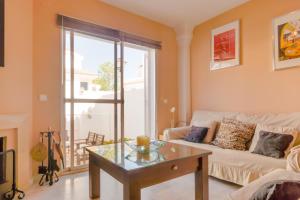 a living room with a couch and a table at Duplex El Manantial in El Puerto de Santa María