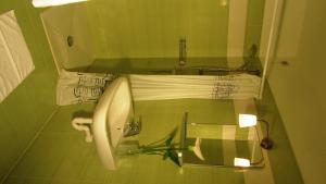 a bathroom with a sink and a toilet with towels at Bar Trattoria Colombina Affittacamere in Bossico