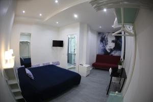 a bedroom with a bed and a red couch at Cico B&B in Naples