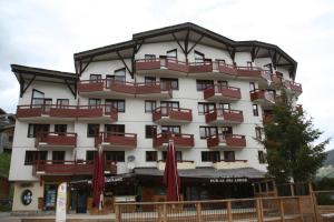 a large building with red umbrellas in front of it at Le Britania 507 in La Tania
