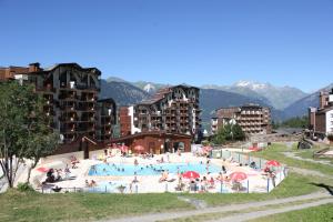 a group of people in a swimming pool in a city at Le Britania 507 in La Tania