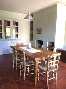 a dining room with a wooden table and chairs at La casina del Poggio in Ponticino