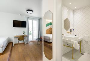 a bathroom with a sink and a mirror at Colors Urban Hotel Thessaloniki in Thessaloniki