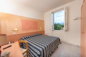 Postel nebo postele na pokoji v ubytování Hotel Apuana