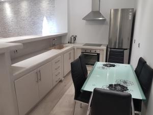 a kitchen with a table and chairs and a refrigerator at Casa Bella in Kamari