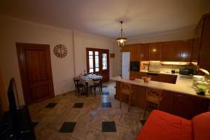 a kitchen with a table and a dining room at My Home In Olympus in Pyrgetós-Larisis