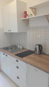 a kitchen with a sink and a counter top at Apartmani Vitturi in Kaštela