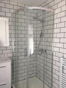 a shower with a glass door in a bathroom at Happy Return Hotel in Blackpool