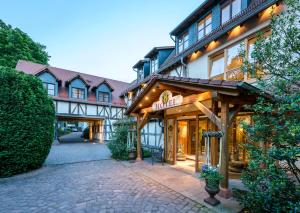 a building with a sign on the front of it at Landhotel Heimathenhof in Heimbuchenthal