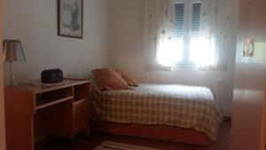 a small bedroom with a bed and a window at La Casa De La Puebla in La Puebla de Montalbán +18 photos